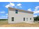 View of the back of the house featuring siding, windows, and a door at 16 Powder Ct, Angier, NC 27501