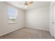 Bright carpeted bedroom with ceiling fan and a sunny window at 16 Powder Ct, Angier, NC 27501