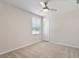 Carpeted bedroom with neutral colors, a ceiling fan, and a bright, sunny window at 16 Powder Ct, Angier, NC 27501
