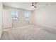 Sunlit carpeted bedroom with great natural light, ceiling fan, and neutral color palette at 16 Powder Ct, Angier, NC 27501