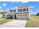 Two-story home with a well-maintained front yard and attached garage at 16 Powder Ct, Angier, NC 27501