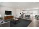 Bright living room with modern furnishings, an open floor plan, and hardwood floors at 16 Powder Ct, Angier, NC 27501