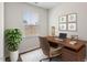 Inviting home office with a modern desk, plush rug, and ample natural light at 16 Powder Ct, Angier, NC 27501