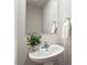 Cozy powder room featuring a pedestal sink, modern fixtures, and neutral décor at 16 Powder Ct, Angier, NC 27501