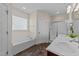 Bright bathroom featuring a soaking tub, shower with glass doors, double vanity and neutral decor at 16 Woodglen Dr, Clayton, NC 27527