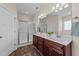 Bright bathroom featuring a shower with glass doors and double sink vanity at 16 Woodglen Dr, Clayton, NC 27527