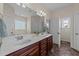 Bright bathroom featuring a double sink vanity, shower with glass doors, and neutral decor at 16 Woodglen Dr, Clayton, NC 27527