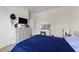 Spacious bedroom with large dresser, TV, closet, vanity and blue comforter at 16 Woodglen Dr, Clayton, NC 27527