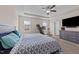 Well-lit bedroom with a ceiling fan, neutral walls, and comfortable carpeting at 16 Woodglen Dr, Clayton, NC 27527