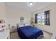 Bright bedroom with a cozy blue comforter, a large window and a cat tree at 16 Woodglen Dr, Clayton, NC 27527