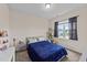 Bright bedroom with a cozy blue comforter, a large window and a cat tree at 16 Woodglen Dr, Clayton, NC 27527