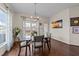 Bright dining space featuring a glass table, backyard views, and stylish accents at 16 Woodglen Dr, Clayton, NC 27527