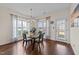Elegant dining room with hardwood floors, glass top table, and ample natural light at 16 Woodglen Dr, Clayton, NC 27527