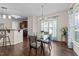 Cozy dining area adjacent to kitchen with hardwood floors and modern chandelier at 16 Woodglen Dr, Clayton, NC 27527