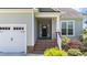 A covered front entrance with brick steps and a white railing leads to the home's front door at 16 Woodglen Dr, Clayton, NC 27527