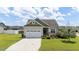 Charming single-Gathering home featuring a two-car garage, manicured lawn, and inviting curb appeal at 16 Woodglen Dr, Clayton, NC 27527