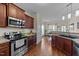 Cozy kitchen featuring stainless steel appliances, brown cabinets, and a convenient open layout at 16 Woodglen Dr, Clayton, NC 27527