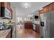 Open kitchen with stainless appliances, granite countertops and hardwood floors adjacent to living and dining areas at 16 Woodglen Dr, Clayton, NC 27527