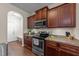 Well-lit kitchen featuring stainless steel appliances, brown cabinets, and lovely countertop decor at 16 Woodglen Dr, Clayton, NC 27527