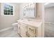 Cozy bathroom featuring a vanity with classic white cabinetry and a mirrored medicine cabinet at 1708 Lake Park Dr, Raleigh, NC 27612