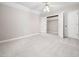 Carpeted bedroom featuring a closet with bi-fold doors and neutral walls at 1708 Lake Park Dr, Raleigh, NC 27612