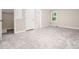 Spacious bedroom featuring neutral carpet, a window, and a closet, perfect for relaxation and storage at 1708 Lake Park Dr, Raleigh, NC 27612