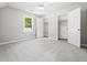 Bright bedroom featuring neutral carpet, large windows, and closet space, providing a cozy atmosphere at 1708 Lake Park Dr, Raleigh, NC 27612