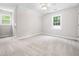 Inviting bedroom with neutral carpet and two windows, offering ample space and natural light at 1708 Lake Park Dr, Raleigh, NC 27612