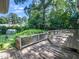 Wooden deck with decorative railing overlooking lush backyard and greenhouse at 1708 Lake Park Dr, Raleigh, NC 27612