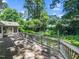 Wooden deck with decorative railing overlooking lush green backyard with mature trees at 1708 Lake Park Dr, Raleigh, NC 27612