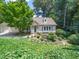 Beautiful home featuring lush greenery, a well-manicured lawn, and attached garage at 1708 Lake Park Dr, Raleigh, NC 27612