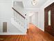 Inviting home foyer with wood flooring and a staircase leading to the upper level at 1708 Lake Park Dr, Raleigh, NC 27612