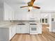 Bright kitchen featuring white cabinetry, countertops, and modern appliances, with hardwood floors at 1708 Lake Park Dr, Raleigh, NC 27612