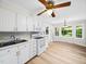 Bright kitchen featuring white cabinetry, countertops, and modern appliances, with hardwood floors at 1708 Lake Park Dr, Raleigh, NC 27612