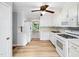 Functional kitchen with white cabinetry, appliances, and hardwood flooring, offering ample space and natural light at 1708 Lake Park Dr, Raleigh, NC 27612