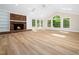Bright and spacious living room featuring a brick fireplace, vaulted ceilings and skylights at 1708 Lake Park Dr, Raleigh, NC 27612