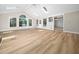 Spacious living room with vaulted ceilings, skylights, hardwood floors, and ample natural light at 1708 Lake Park Dr, Raleigh, NC 27612