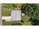 Overhead shot of a house with a gray roof and a patio set, surrounded by a green lawn and trees at 174 Sequoia Dr, Louisburg, NC 27549