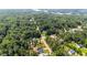 Aerial view showcasing a neighborhood nestled within a dense forest, near a lake and a water tower at 174 Sequoia Dr, Louisburg, NC 27549