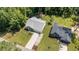 Aerial view of well-maintained home featuring a large driveway, manicured lawn, and lush landscaping at 174 Sequoia Dr, Louisburg, NC 27549