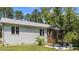 This home features a back patio and screen porch overlooking a lush, green lawn and backyard at 174 Sequoia Dr, Louisburg, NC 27549