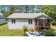Back view of a lovely home, with a back patio and screen porch, perfect for outdoor relaxation at 174 Sequoia Dr, Louisburg, NC 27549