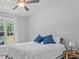 Bedroom featuring a cozy bed and a large window, a ceiling fan, and neutral decor and a side table at 174 Sequoia Dr, Louisburg, NC 27549