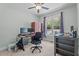 Bedroom featuring a cozy workspace with a large window, ceiling fan, wood floors and neutral decor at 174 Sequoia Dr, Louisburg, NC 27549