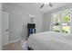 Bedroom featuring a cozy bed and a large window, a ceiling fan, and neutral decor with a mounted television at 174 Sequoia Dr, Louisburg, NC 27549
