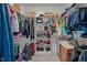 Walk-in closet features shelving and hanging rods to efficiently organize personal belongings in a new home at 174 Sequoia Dr, Louisburg, NC 27549