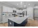 Beautiful kitchen features a large island with white countertops and stainless steel appliances at 174 Sequoia Dr, Louisburg, NC 27549