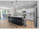 Modern kitchen featuring an island, stainless steel appliances, and pendant lighting at 174 Sequoia Dr, Louisburg, NC 27549