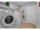 Well-organized laundry room with modern washer, dryer, shelving, and convenient access to the home at 174 Sequoia Dr, Louisburg, NC 27549
