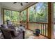 Relaxing screened porch with comfortable seating and a view of the lush, wooded backyard at 174 Sequoia Dr, Louisburg, NC 27549